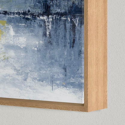 Abstract painting with a wooden frame on a light gray wall