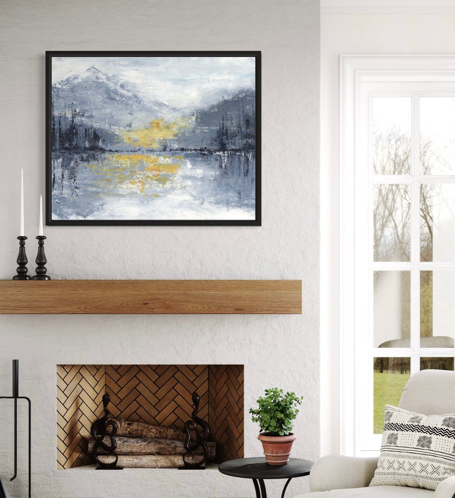 Living room with a fireplace, framed abstract painting, and decorative items.