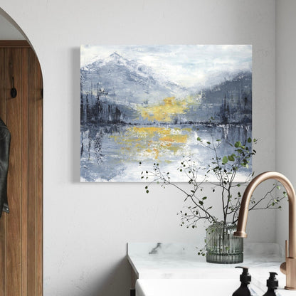 Abstract painting of a mountain landscape with a yellow peak in a modern kitchen.