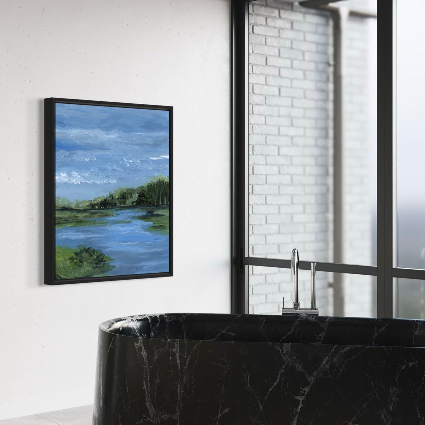 Framed artwork of a landscape with a black marble bathtub in a modern bathroom.