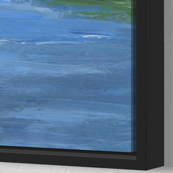 Close-up of a framed artwork with a blue abstract design and black frame.