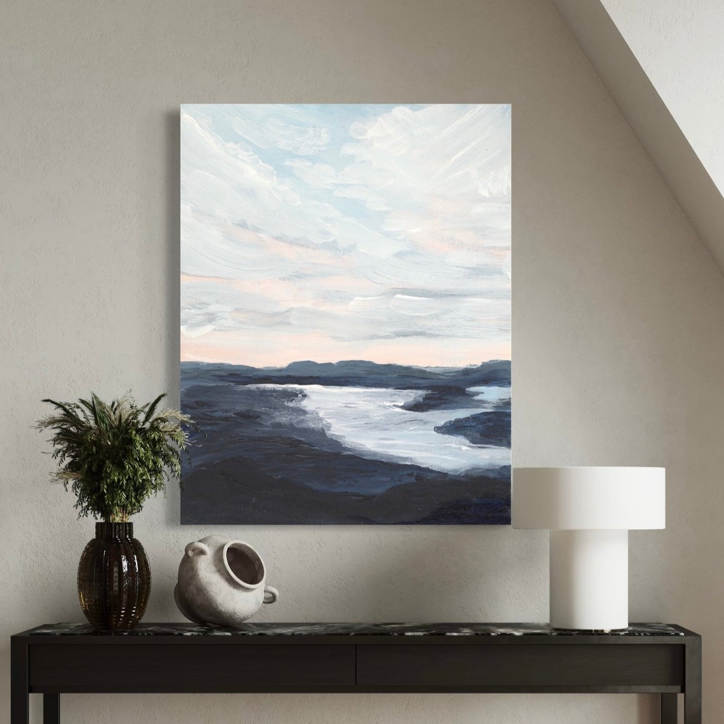 Abstract landscape painting on a wall above a console table with decorative items.