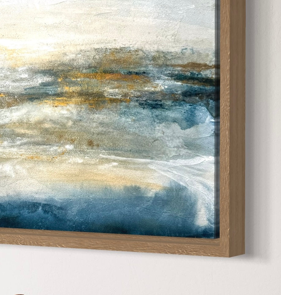 Abstract painting with gold and blue tones in a wooden frame.