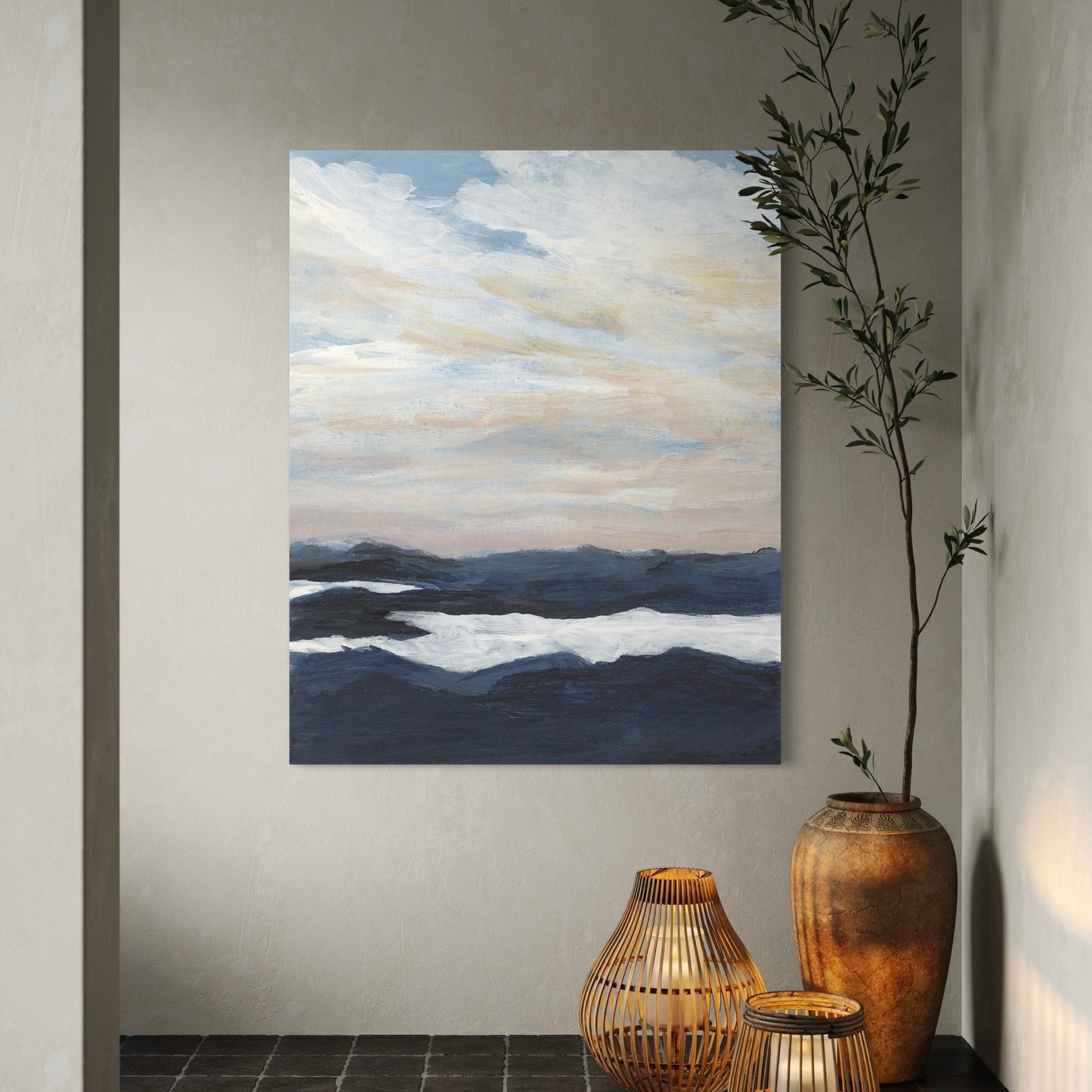 Painting of a landscape with mountains and sky in a room with decorative vases.  Entrance to spa