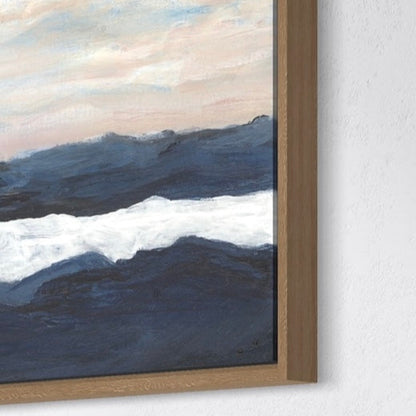 Framed artwork of wavy ocean painting on a white wall