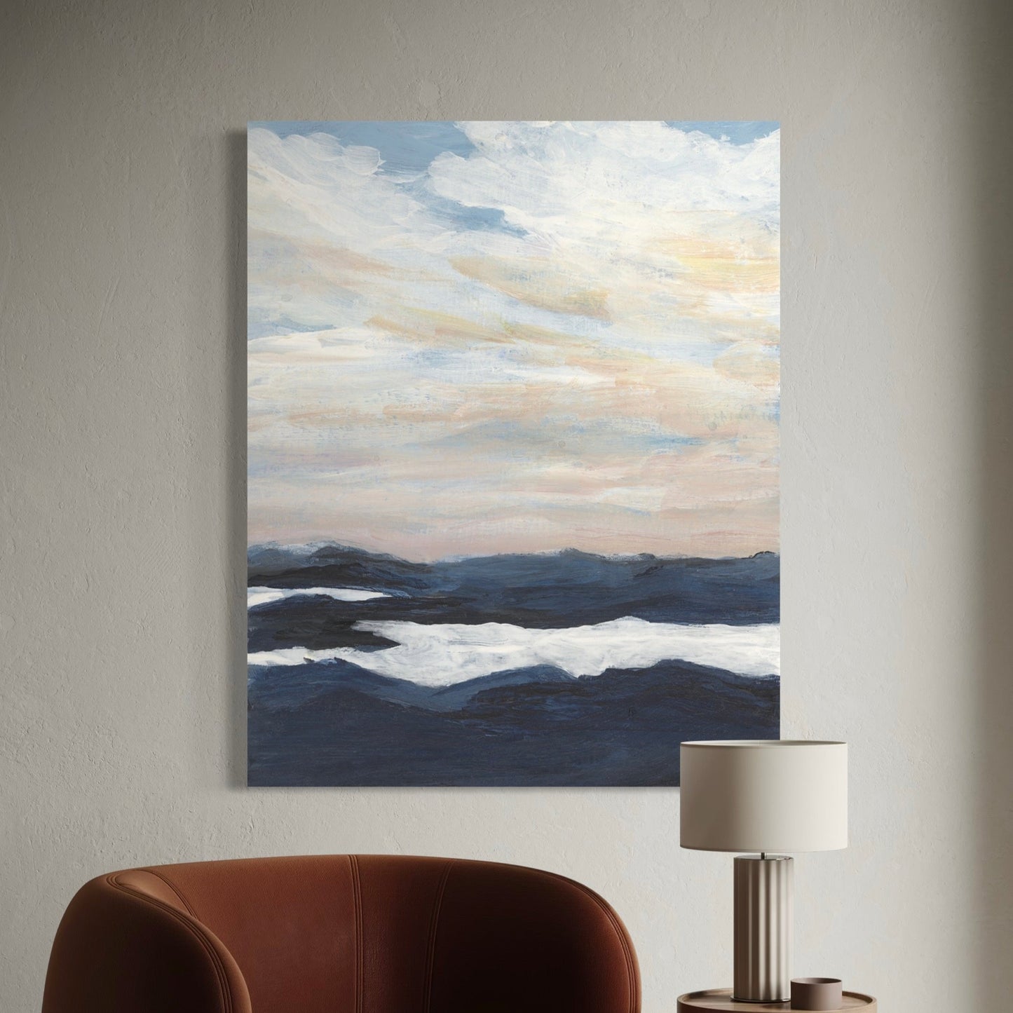 Painting of a landscape with clouds and water on a wall above a brown chair.
