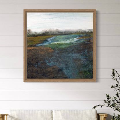 Framed landscape painting on a white wall with a plant to the right.