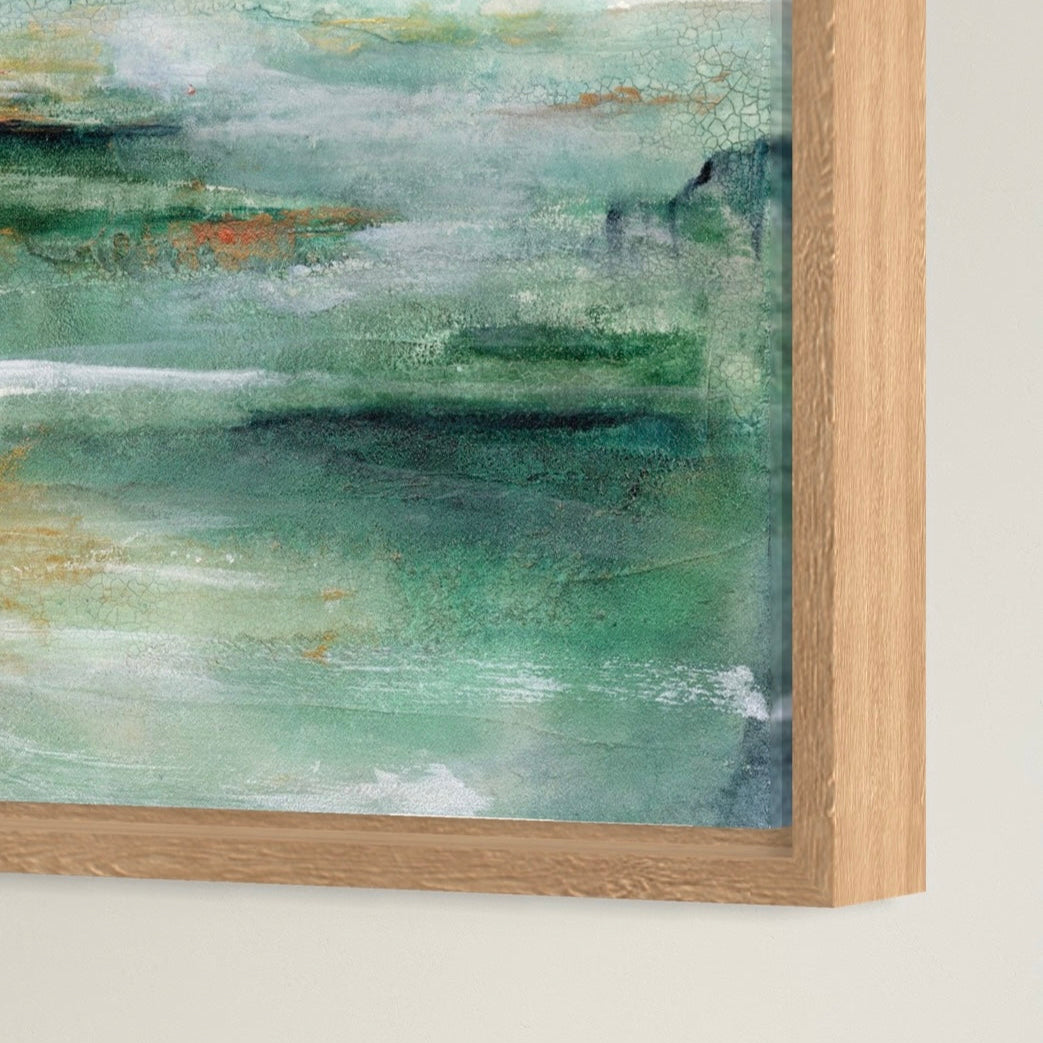 Abstract textured blue-green painting with a wooden frame on a white wall