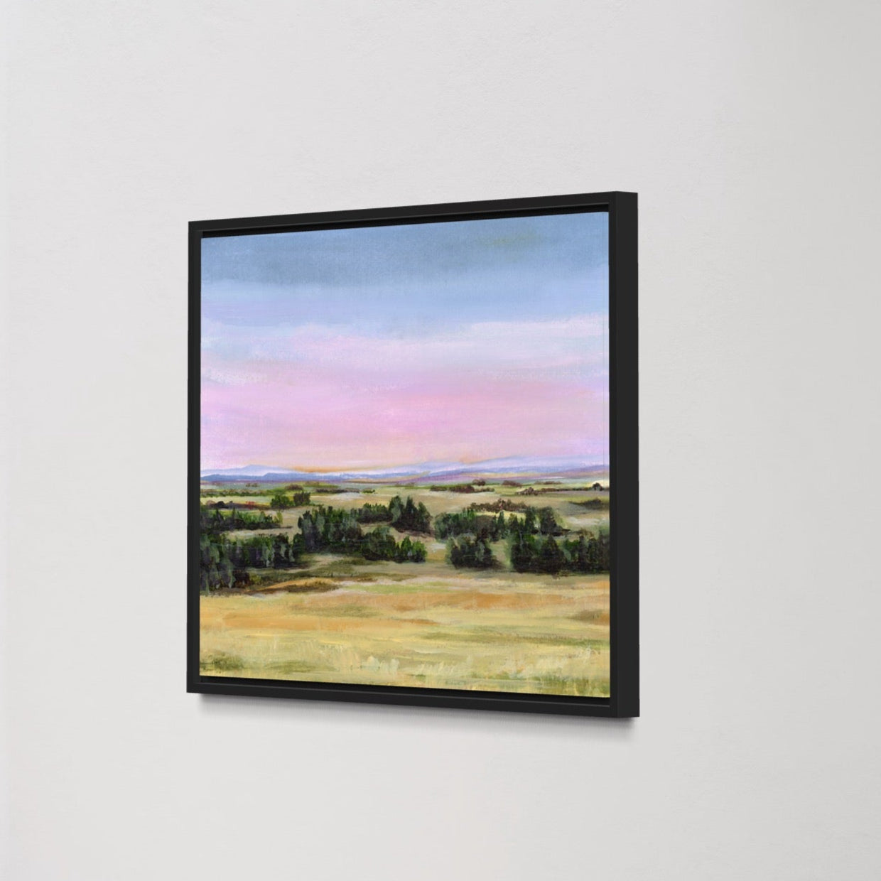 Framed landscape painting on a white wall