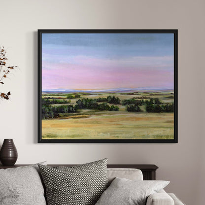 Framed landscape painting on a wall above a sofa