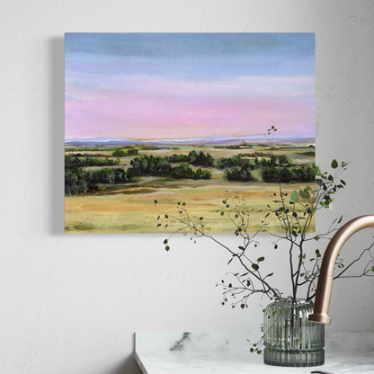 Painting of a landscape with fields and trees on a wall above a kitchen sink.