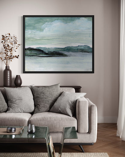 Living room with a gray sofa, glass coffee table, and framed abstract artwork on the wall.