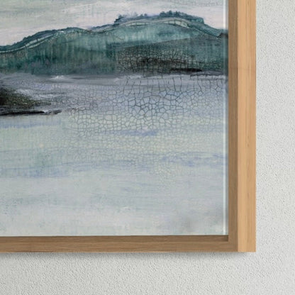 Framed landscape painting with cracked glass effect on a textured wall.