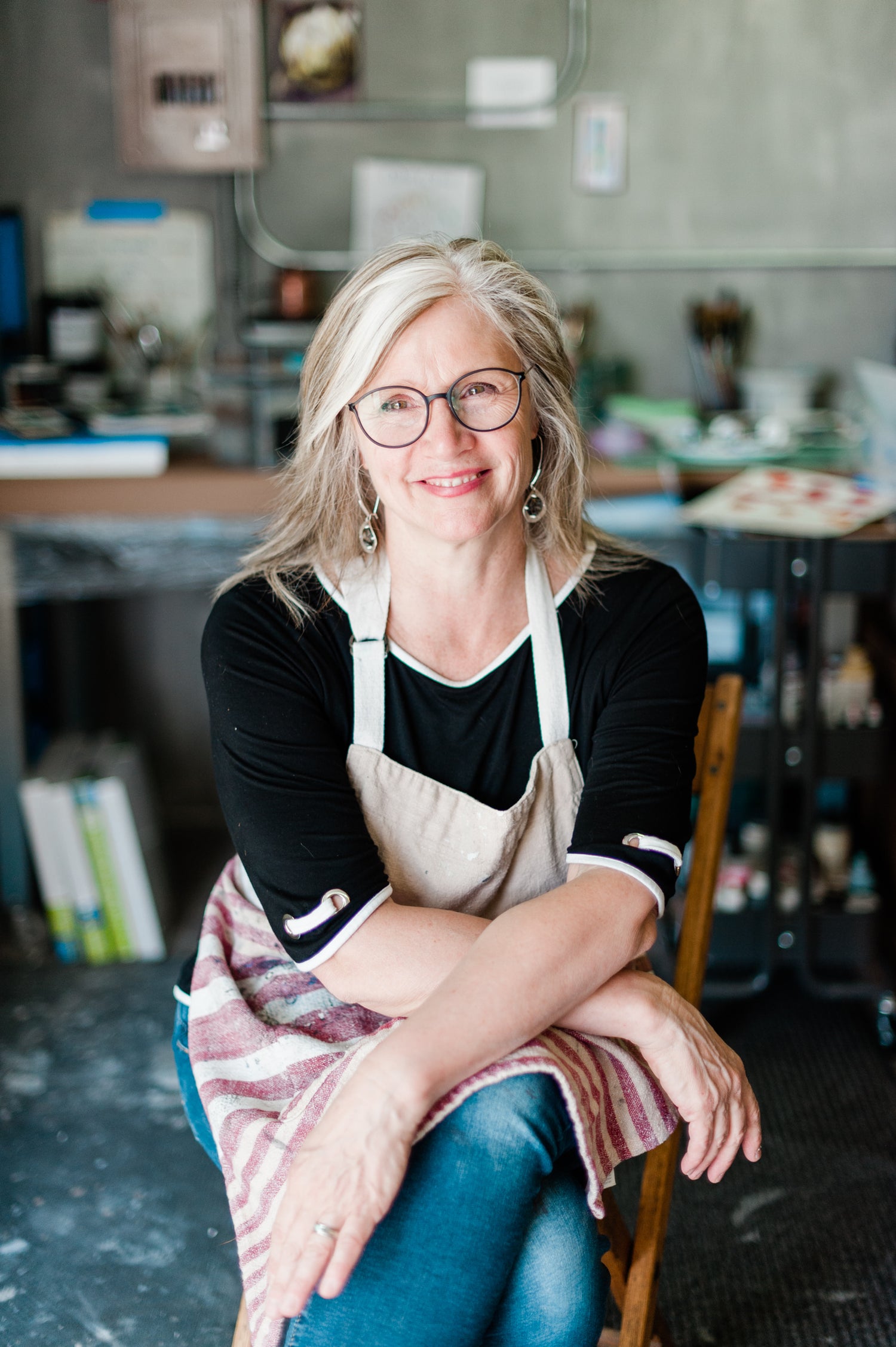 Woman wearing an apron sitting in a kitchen